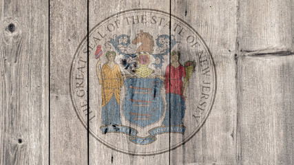 USA Politics News Concept: US State New Jersey Seal Wooden Fence Background