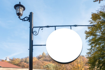 Blank round signboard, advertising, information board on pole in the park