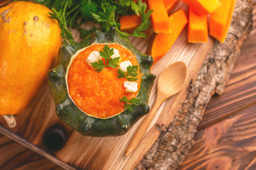 Bright tasty pureed pumpkin soup served in a hollowed pumpkin