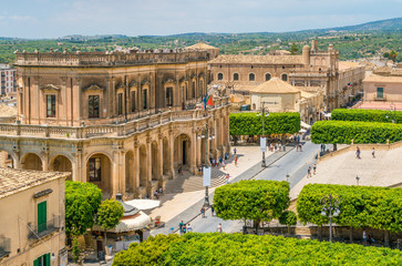 Panoramic view in Noto, with the Palazzo Ducezio and the Church of San Carlo. Province of Siracusa, Sicily, Italy. - obrazy, fototapety, plakaty