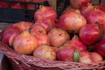 Red and yellow pomegranates at the market