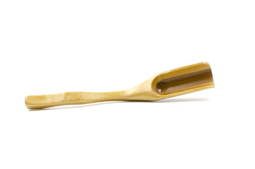 Wooden spoon for tea or spices is on a white background