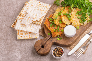 Homemade traditional potato pancakes Hanukkah celebration food with crunchy matzo