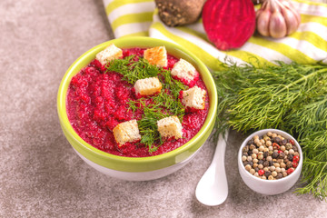 Bright tasty pureed beetroot soup with ingredients. Healthy food
