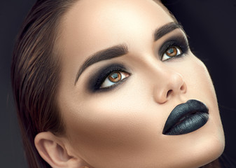 Fashion model girl portrait with trendy gothic black make-up. Young woman with black lipstick, dark...