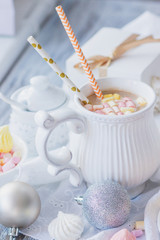 Fototapeta na wymiar Cup of cacao with marshmallow, meringues and different Christmas decorations