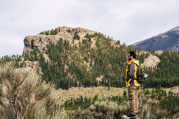 Naklejka premium Man Traveler on mountain summit with clear sky around Travel Lifestyle success concept adventure survival vacations outdoor for people love outdoors parks and scenic places. Discover nature