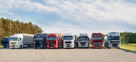 A long range of various types and colors of trucks on a truck stop. © Wlodzimierz