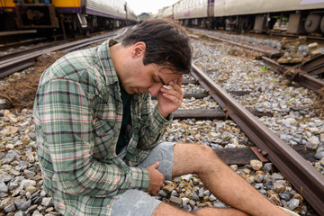 Sad tourist man at the railway station in Bangkok Thailand