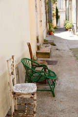 variety of old chairs in alley