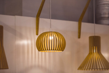 Suspended wooden lamp. Modern chandelier of wood in Scandinavian style