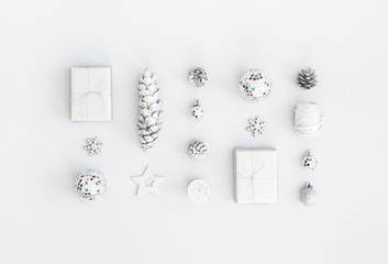 Christmas composition. Christmas gifts, silver decorations on pastel gray background. Flat lay, top view, copy space