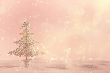 Silver glitter Christmas tree on pink background with lights bokeh, copy space. Greeting card for new year party. Festive holiday concept