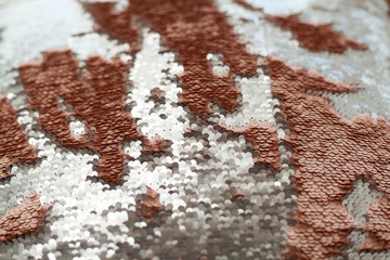 Sequins close-up macro. Abstract background with gold sequins color on the fabric.