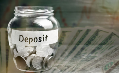 Glass jar with coins and the inscription 