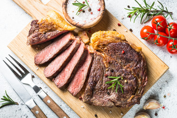 Grilled beef steak ribeye on wooden cutting board. 