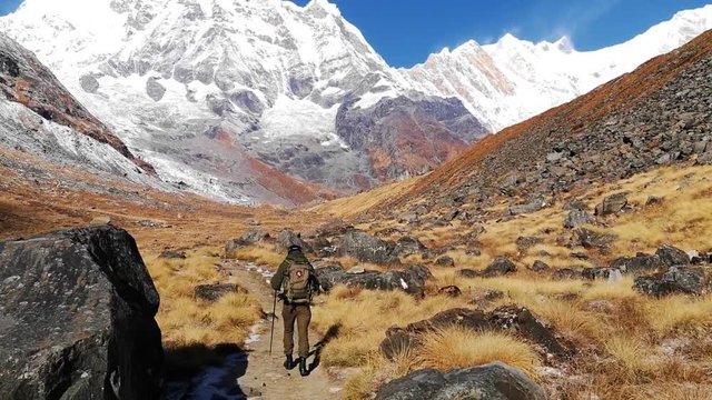 Hiker walking on trekking trail to Annapurna Base Camp, Himalayas, Nepal. POV.