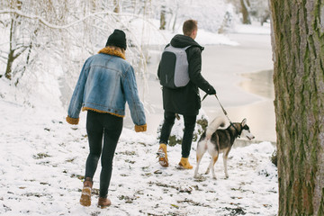 couple with huskies