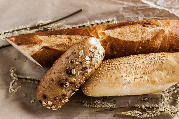 mix of different varieties of bread lying on a wooden table