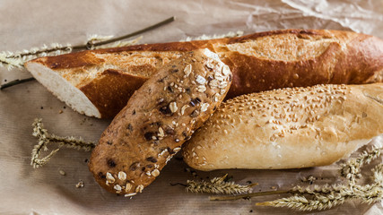 mix of different varieties of bread lying on a wooden table