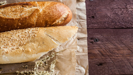 mix of different varieties of bread lying on a wooden table