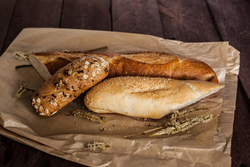 mix of different varieties of bread lying on a wooden table