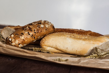 mix of different varieties of bread lying on a wooden table