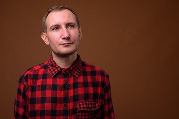 Studio shot of man against brown background