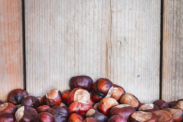 Chestnuts with wooden background