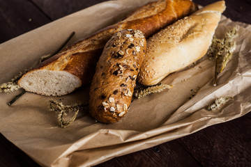 mix of different varieties of bread lying on a wooden table