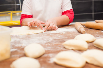 Young children make dough products. Hands closeup