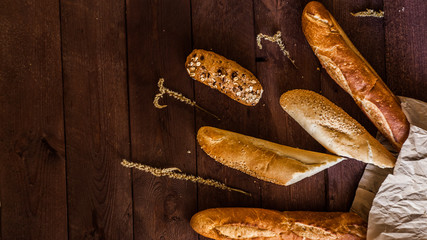 Mixed breads background on wooden table, top view for your text.