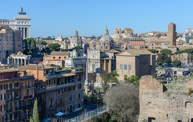 Obraz premium View of the Roman Forum and the city of Rome from Palatine Hill. The forum with its adjoining buildings is located in the center of ancient Rome. Temples, arches, basilicas and other buildings. 