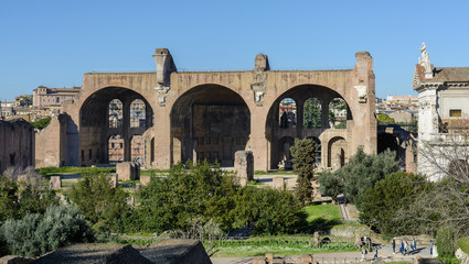 Fototapeta premium View of the Roman Forum and the city of Rome from Palatine Hill. The forum with its adjoining buildings is located in the center of ancient Rome. Temples, arches, basilicas and other buildings. 