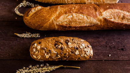 mix of sorts of baguettes on a wooden table. Bakery products.