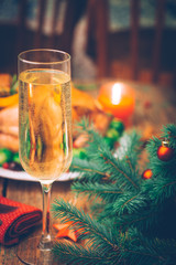 Whole baked Christmas chicken with side dish, orange, rosemary and thyme on a wooden background. Rustic table setting. Christmas dinner.