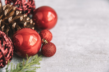 Christmas composition with red baubles and pine cones on wooden background. Christmas concept decoration
