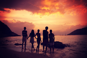 Friends on beach at sunset