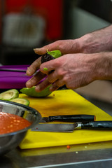 Male Chef Pealing Avocado for  Wedding Meal