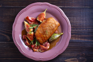 Duck breast with pancetta, rosemary and figs, baked in honey sauce. overhead, horizontal