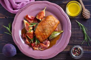 Duck breast with pancetta, rosemary and figs, baked in honey sauce. overhead, horizontal