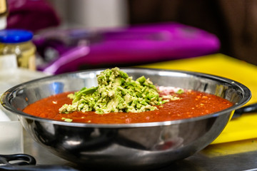 Tomatoe Sauce With Avocado Pieces in Stainless Steel Bowl