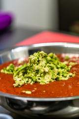 Tomatoe Sauce With Avocado Pieces in Stainless Steel Bowl