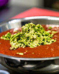 Tomatoe Sauce With Avocado Pieces in Stainless Steel Bowl