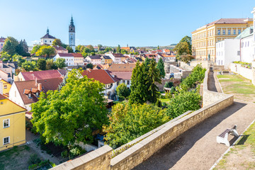 Litomerice cityscape with baroque St. Stephen's Cathedral and bell tower, Litomerice, Czech Republic. View from fortification walls and baileys.