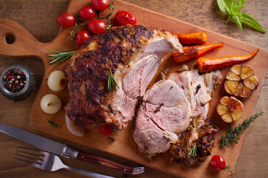 Baked Ham With Vegetables, Rosemary And Thyme On Chopping Board. Overhead, Horizontal