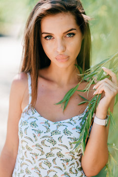 Closeup lifestyle portrait of celebrity female model.  Beautiful girl face on abstract nature background. Cheerful amazing young woman face expression. Sexy blue eyed babe. Glamour youth appearance.