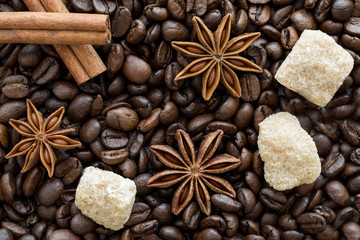 cinnmon sticks, brown sugar and anise stars on coffee beans background.