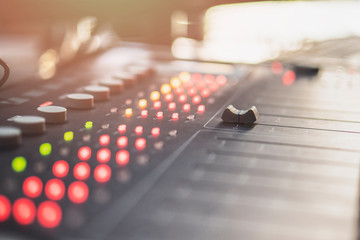 Professional audio mixing console with faders and adjusting knobs - radio / TV broadcasting