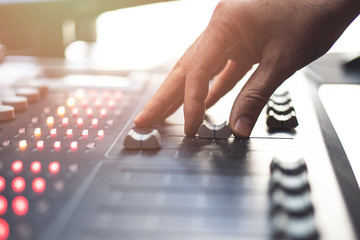 Professional audio mixing console with faders and adjusting knobs - radio / TV broadcasting